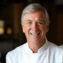 Portrait of Chef Tom Ainsworth, a friendly man with a warm smile, wearing a chef's jacket.
